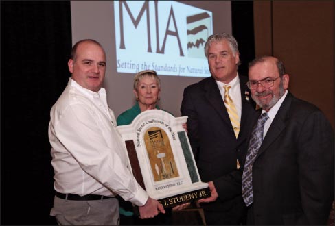 Regis Studeny (far right) accepts the 2015 Natural Stone Craftsman of the Year award from award sponsors Patrick Perus (Polycor) and Brenda Edwards (TexaStone Quarries) and 2015 MIA President, Dan Rea (Coldspring). 