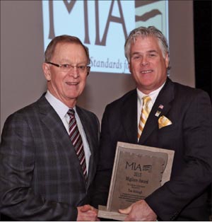 Tom Schlough (Left) receives the Migliore Award for Lifetime Achievement from 2015 MIA President, Dan Rea (Coldspring). 