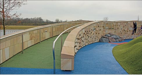 Perimeter and climbing-feature wall at the Summit Park in Blue Ash, Ohio. The rich, natural earth tones of Crab Orchard sandstone on the climbing wall is a perfect match of stone to purpose.