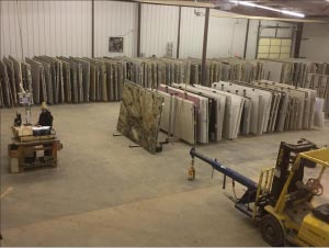 New slab storage layout, in progress. Two lanes of slab racks gave Solid Surface Designs safer and easier access when extracting slabs from a rack. They were also able to separate natural stone and engineered stone materials, making it easier to track inventory.