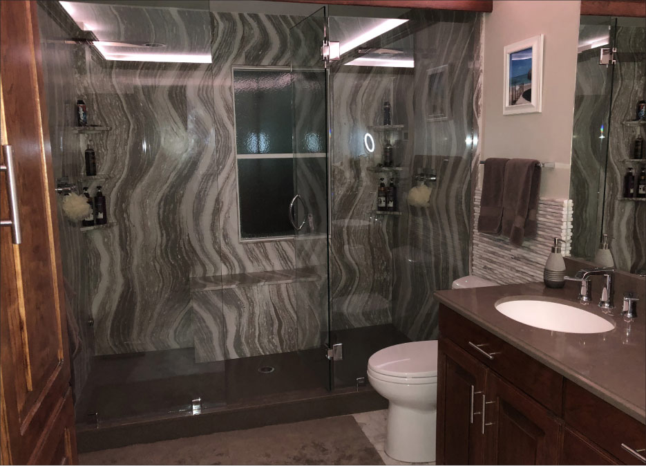 The Shower surround and seating in this master bath features Cambria Oakmoor, and sits atop a cultured marble floor pan base. The vanity is done in Cambria Ramsey with an integrated Corian sink, all fabricated and installed by Premiere Surfaces.