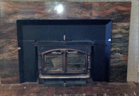 Residential fireplace surround fabricated in quartz;