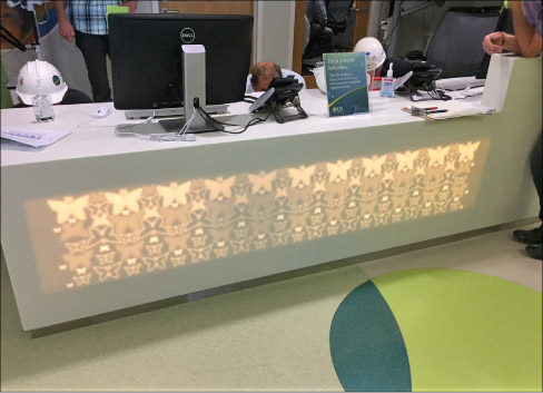 Backlit Corian desk, milled to different depths and including complex butterfly shapes, for Strong Children’s Hospital