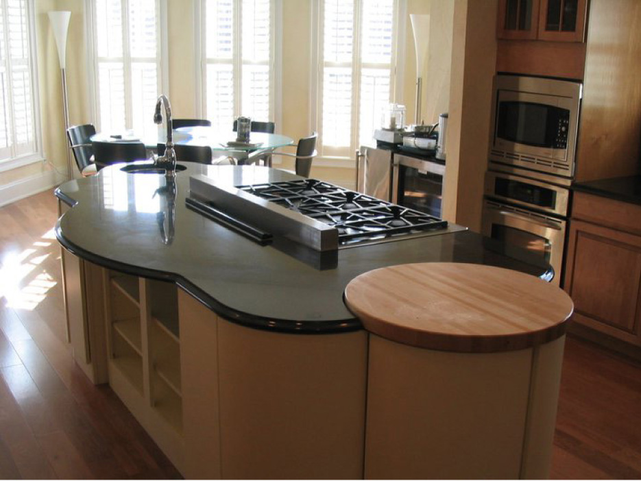 The curving, free-form island in this custom kitchen is a beautiful marriage of granite and wood