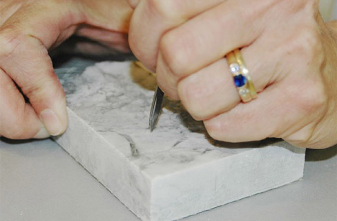 The knife blade test is a simple and easy way to determine if that slab is marble of quartzite.