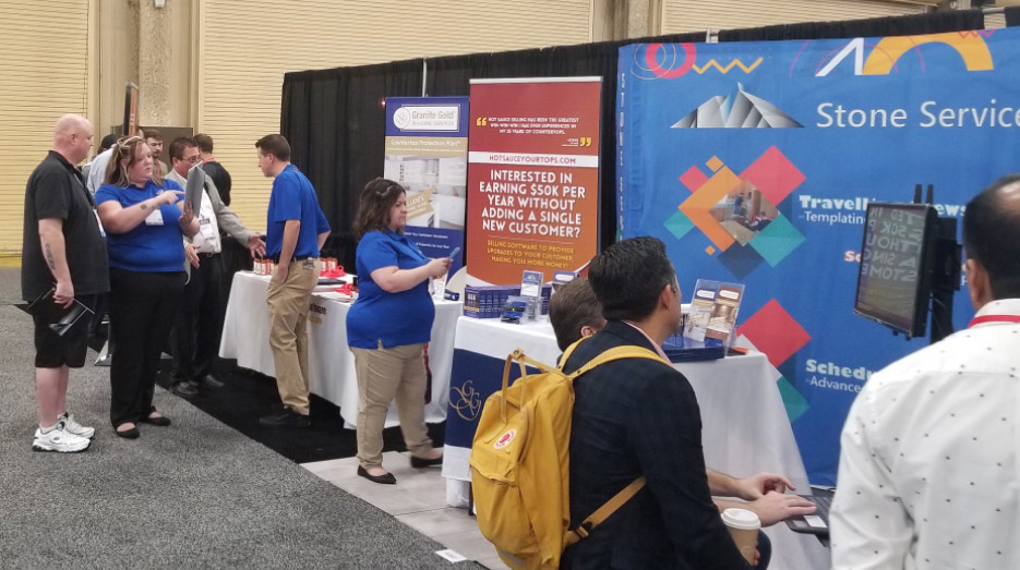 Stone Services Group and their product displays were busy at TISE. From left, in blue: Jacquie Cook, Anthony Anderson and Christina Scobey.