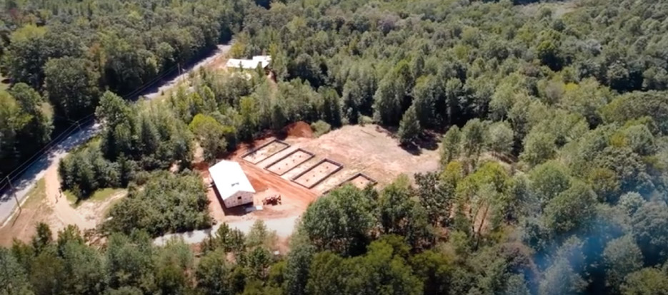 Aerial view of Darkhorse Lodge, with individual cabins under construction. The building at the center is Bowman Hall, named after SPC Tim Bowman.  BB Industries donated materials for ADA-compliant bathroom vanities to aid in the construction of this retreat.