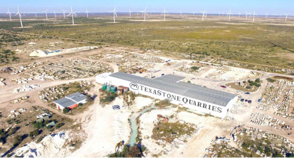 Wind turbines stand tall on the horizon, with the TexaStone processing and fabrication facility situated between a wind turbine farm, and oil and gas wells tapping deep into the limestone and shale geology of the Central Texas plains.