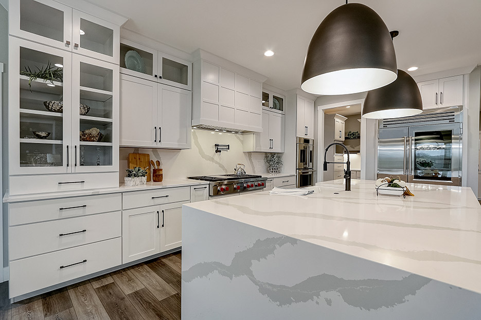 Silestone Bianco Calacatta mitered cubic island and full height splash grace this spacious, open-plan working kitchen.