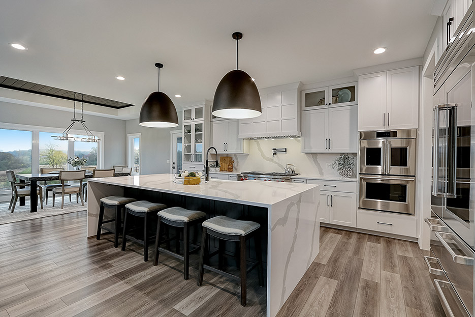 Silestone Bianco Calacatta mitered cubic island and full height splash grace this spacious, open-plan working kitchen.