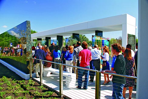 Visitors attending the dedication ceremony walk through the Remembrance Plaza located at Lynn University in Boca Raton, FL