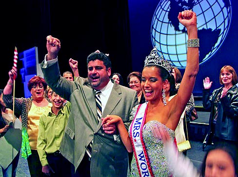 April's husband George Lufriu cheers and celebrates her victory. April continues to manage Lufriu Marble, Inc., a granite and marble fabrication business where her husband, George, is the president and she is vice president. The business specializes in custom, natural-stone fabrication projects like pools, bathrooms, fireplaces and countertops.