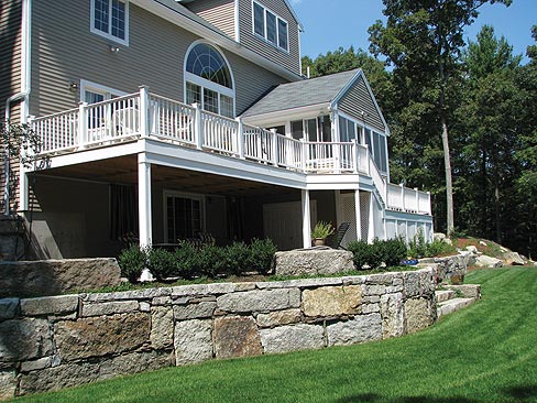 Olde New England Granite supplied the reclaimed granite block and cap material to form this beautiful and functional retaining wall and steps