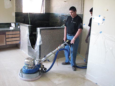 One of my Master Stone Refinishers, Humberto Reveles, demonstrating proper cord management as his apprentice Julio looks on.