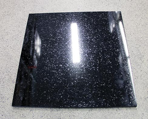 Black granite polished side; smooth surface profile results in high specular reflection gloss and deep color.