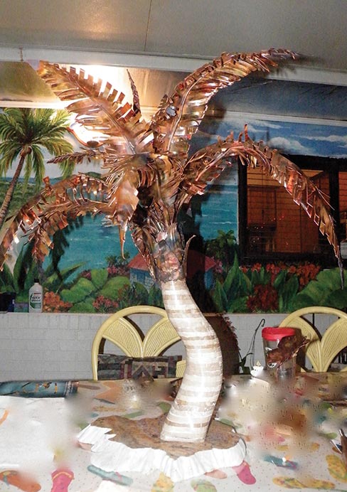 Vince’s artistic side: The palm tree base is made of laminated pieces of tumbled marble epoxied together and than shaped to the curving tree base. A topper of hand-cut copper was created for the palm tree fronds, then welded together. “It’s kind of crafty and unusual. We do that as fun.”