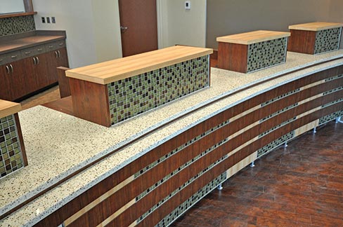 Amber Pearl Icestone was specified for this bank teller station, one of many jobs to the credit of Artistic Stone Design. “Our type of commercial work is basically medical office buildings, reception desks and bank lobbies. We don’t do any hotels or apartments,” noted Owner Jon Rathke.