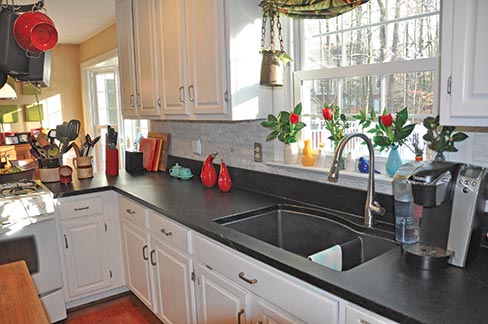 Alberene Church Hill Reserve soapstone kitchen features a light colored rustic backsplash created with a Tomahawk Stone Splitter sold by Braxton-Bragg. “We are lucky here in Virginia because we currently have the only functioning soapstone quarry in the country, about 80 miles from here.” 