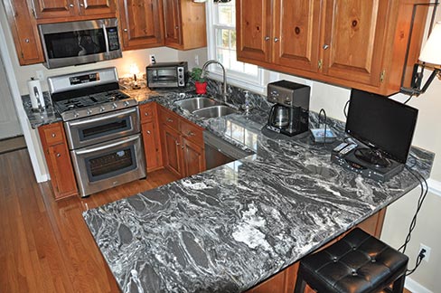 A simple kitchen with a very dramatic countertop. 3cm Paradiso Silver granite was used to highlight this charming country kitchen. “We have a lot of designers we work with and that is part of our core business. We go after what I call ‘C’ customers. They are the smaller home builders that are probably a little higher end.”