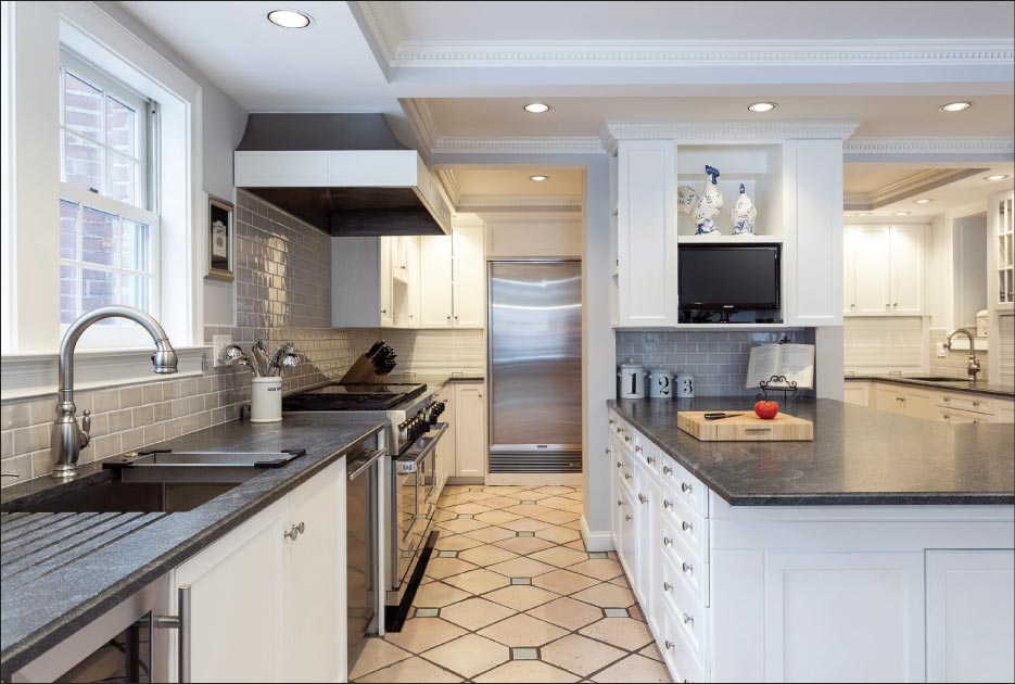 Four slab kitchen in Longmeadow, Mass., with 3cm honed Jet Mist granite to match an existing hearth in the house. Matching slabs of Jet Mist granite were selected by the client, and installed in three rooms. 