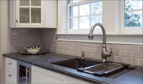 Longmeadow, Mass., kitchen  features 10mm cove edge and drainboard runnels in Jet Mist granite from IGM, and Subway backsplash tile.