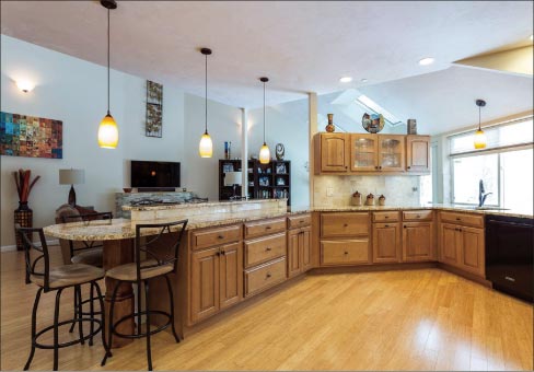 Kitchen in the Deer Path Farms, Hudson, Mass. community of homes, designed and built by Gerald Sarno, featuring 3cm granite and backsplash tile from The Tile Shop.   Photo by Gregg Ferraris