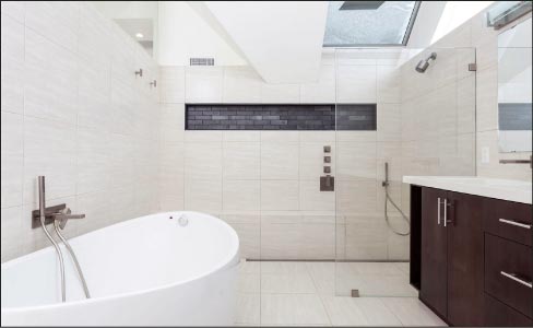 Bath and barrier-free shower for a private residence in the Deer Path Farms development, Hudson, Mass. Materials used  include a combination of largeformat tiles for the floor and walls.  Photo by Gregg Farraris