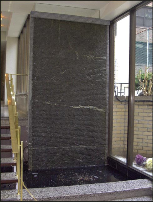 12 foot Limestone waterfall with hand chiseled face, installed at a residence on East 49th Street in NYC.