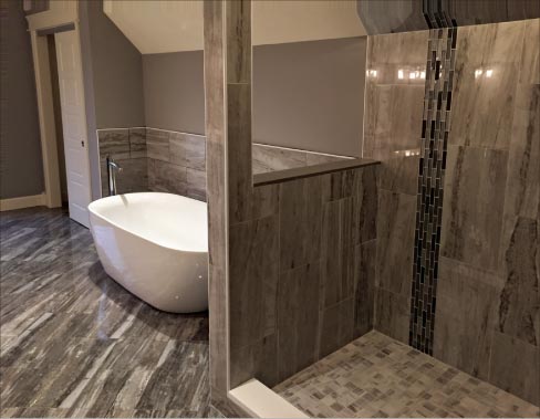 Bathroom in Hadley, Mass., for Ron Bercume, Bercume Builders features 12 x 24 polished porcelain from MSI, with a glass tile border.