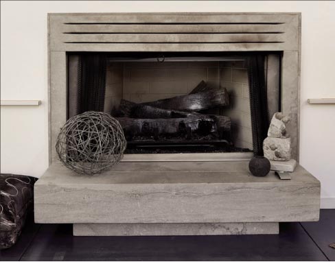 Modern style fireplace showcasing the Napoleon cut;  design and fabrication by Freddie Flores.