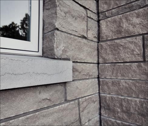 Examples of Phenix Split-Face veneer on a private residence. This project used Napoleon Grey cut in an ashlar pattern, with solid, saw cut sill pieces.