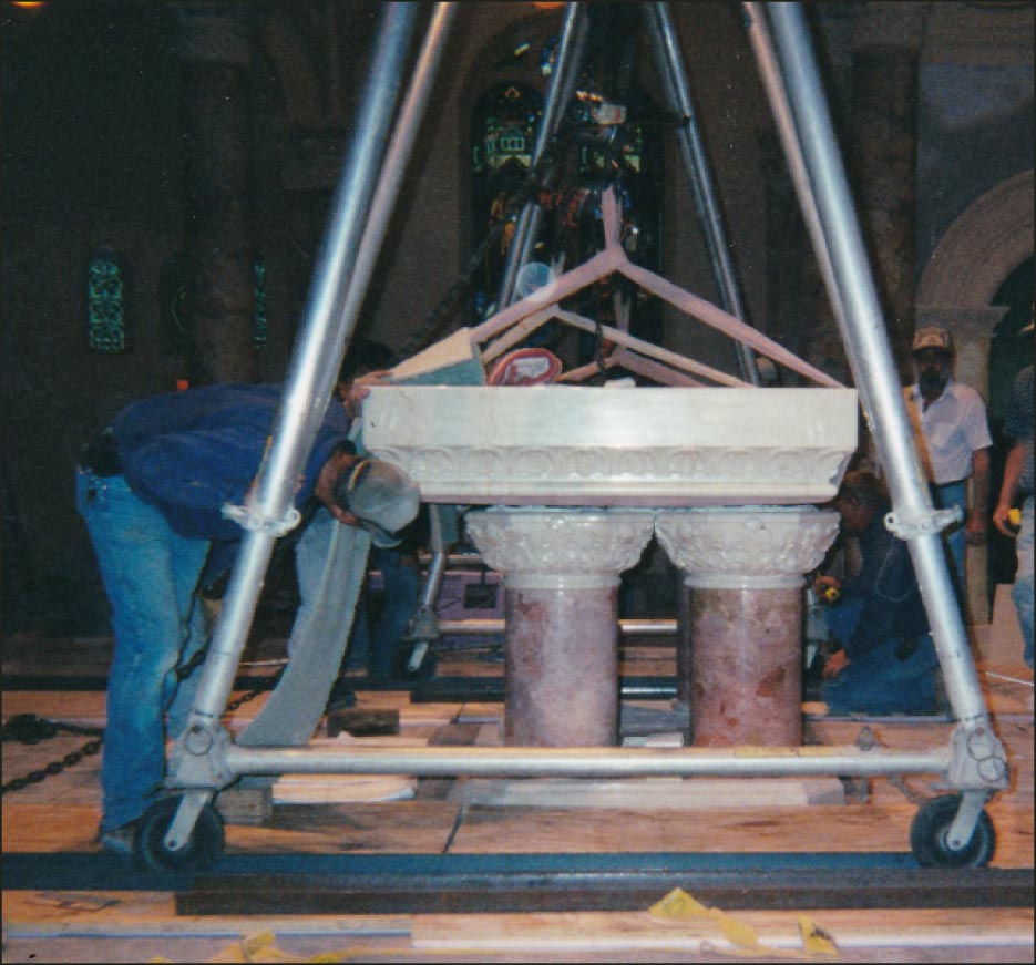 Step 11: We have to back up a little bit, but we are almost there. The altar top was centered just minutes after this photo was taken. The chainfalls are slowly ratcheted down until the piece is resting on the base. Large rubber mallets are used to tap the piece into its final centered position.