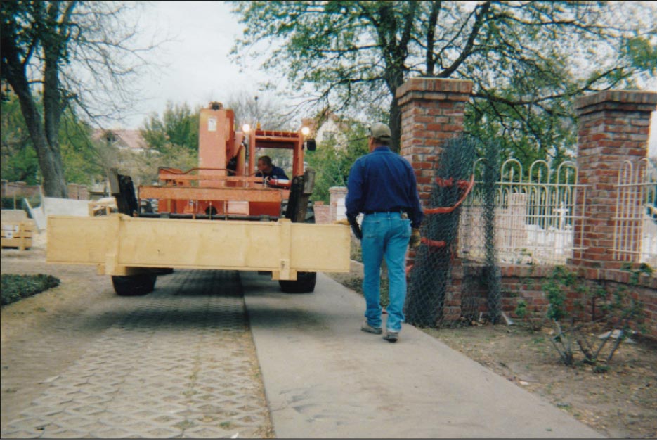 Step 2: Carefully moving the crate from the yard towards the building entry point.