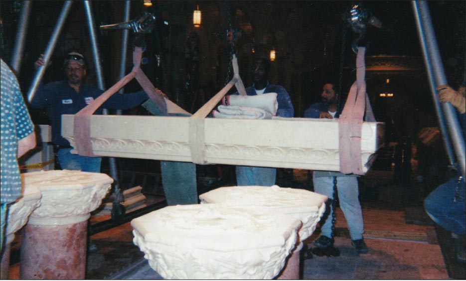 Step 9: The piece is being moved forward over the top of the four column supports. Everyone in the photo is holding their breath at this moment!