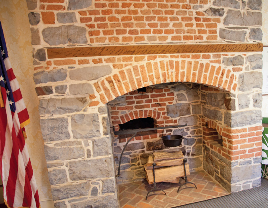 This  solid and functional fireplace is the real deal and one of two cooking areas in the kitchens of the Gemeinhaus. Note the baking oven in the back.