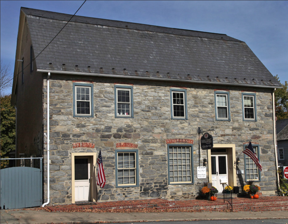 Believed to have been a bridge toll house, this trim, restored building now serves as a combination realtors and law office.