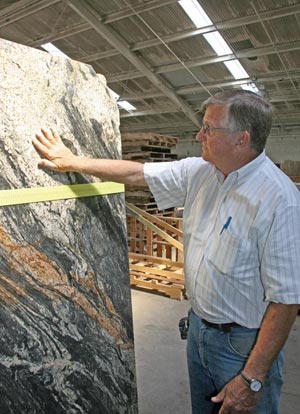 Kirby Webb Inspects a slab of Magma textured granite at Craftstone Products in Soddy-Daisy, TN