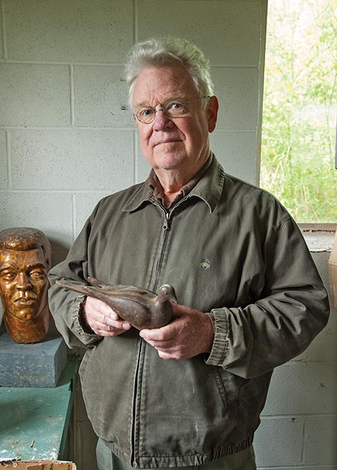 Bill Ralston, at his Bell Buckle, TN studio, roughs out a limestone sample of his arts awards sculpture with hammer and chisel.