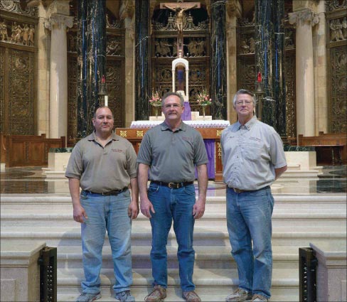 In front of the St Paul’s Cathedral altar, from left:  Luis Campoverde, Tim Lesnar, and Rich Barone.