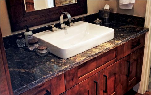 2cm Purple Dunes Granite vanity with a chiseled edge combines a rustic countertop with a modern sink and faucet combo for a “mountain modern” look.