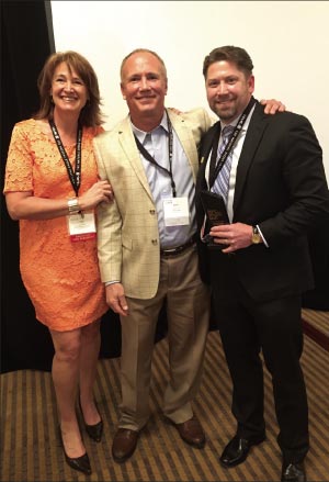 Rob Barnes (right) accepts the 2015 BSI Person of the Year award from EVP Jane Bennett and 2014 BSI Person of the Year Daniel Wood (Lurvey Landscape Supply). 