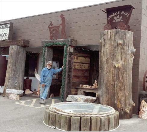 Pete the Miner at the timber entryway leading to his gallery, museum, and working studio.