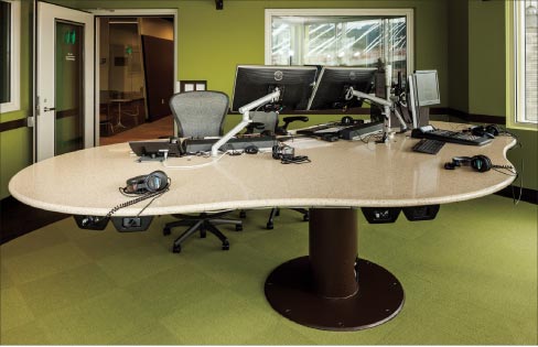 Three projects showcase the curve-cutting capability of the Robo Sawjet. Above: Rotating, hydraulic DJ table for a radio station in Portland used three full slabs of DuPont Zodiaq Coriander quartz. 