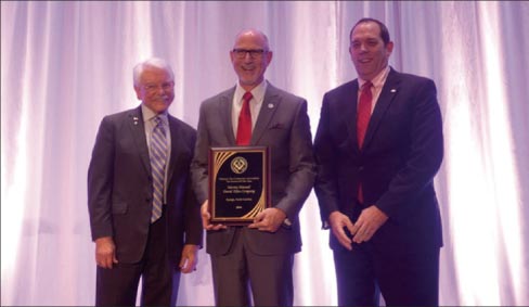 Martin Howard, center, President of the NTCA was the surprised recipient of the Tile Person of the Year award. 