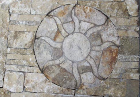 Limestone medallion in dry set patio flags. Stander: “The stone in these photos is all limestone from Weeping Water. The gold colored limestone is found close to the surface in ledges and has been harvested since the mid 1800s; the white colored vine table is from the mines which have been quarried since the mid 1950s.”