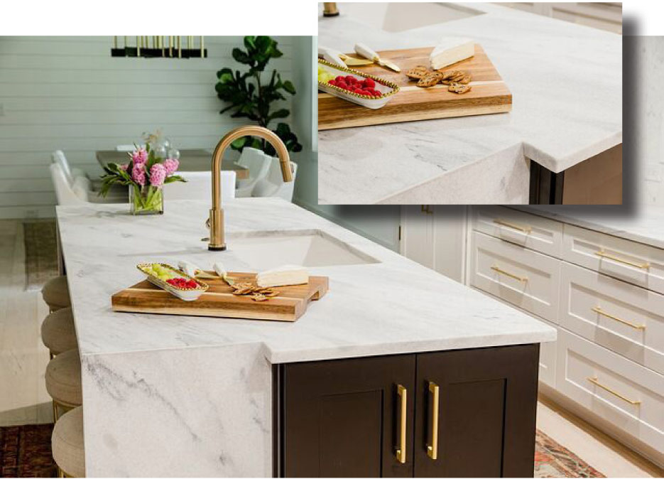 Designer Krystine Edwards insisted on using marble in her kitchen over other surface materials. A notched detail in the waterfall island highlights built-in cabinetry in a dramatic black.