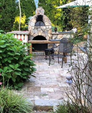 Working wood-fired fieldstone oven & rustic limestone slab tables.