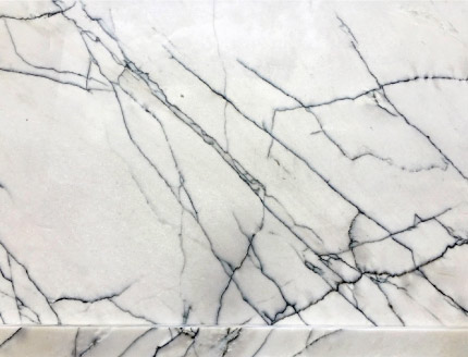 By contrast, marble and quartzite both have a smaller grain size and all the grains in the white areas are the same color. This is Lincoln marble.