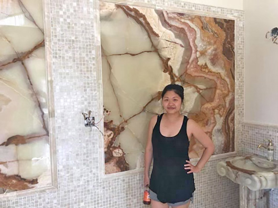 This elegant master bath features two onyx wall panels inset in the tiled walls. 