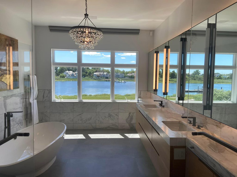 Marble master bath with walk-in shower and double vanity with mitered apron.